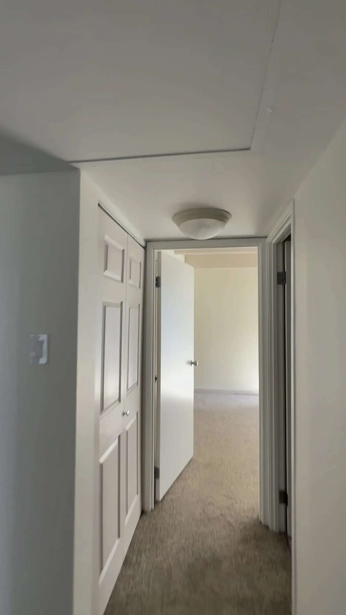 Finished smooth ceiling and clean hallway after asbestos popcorn ceiling abatement and air clearance in a Denver condo