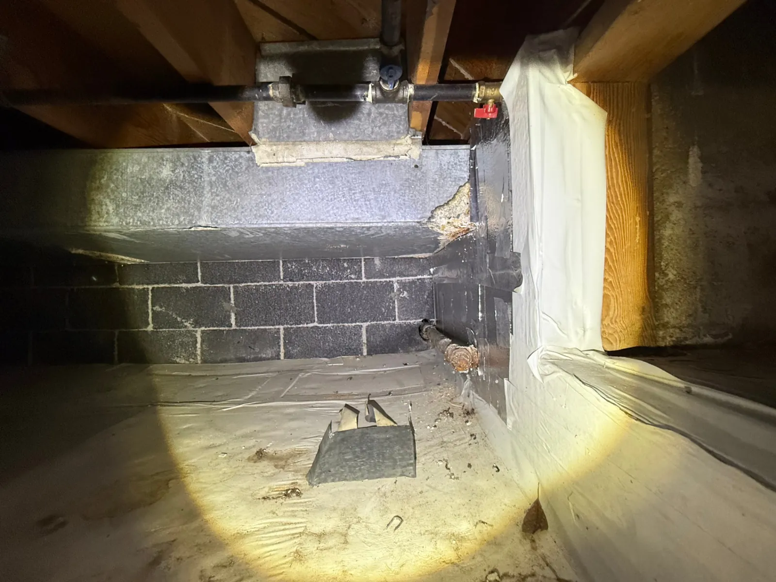 Asbestos pipe wrap insulation found inside a Denver home crawl space, scoped for licensed abatement and CDPHE-compliant disposal by Advantage Environmental