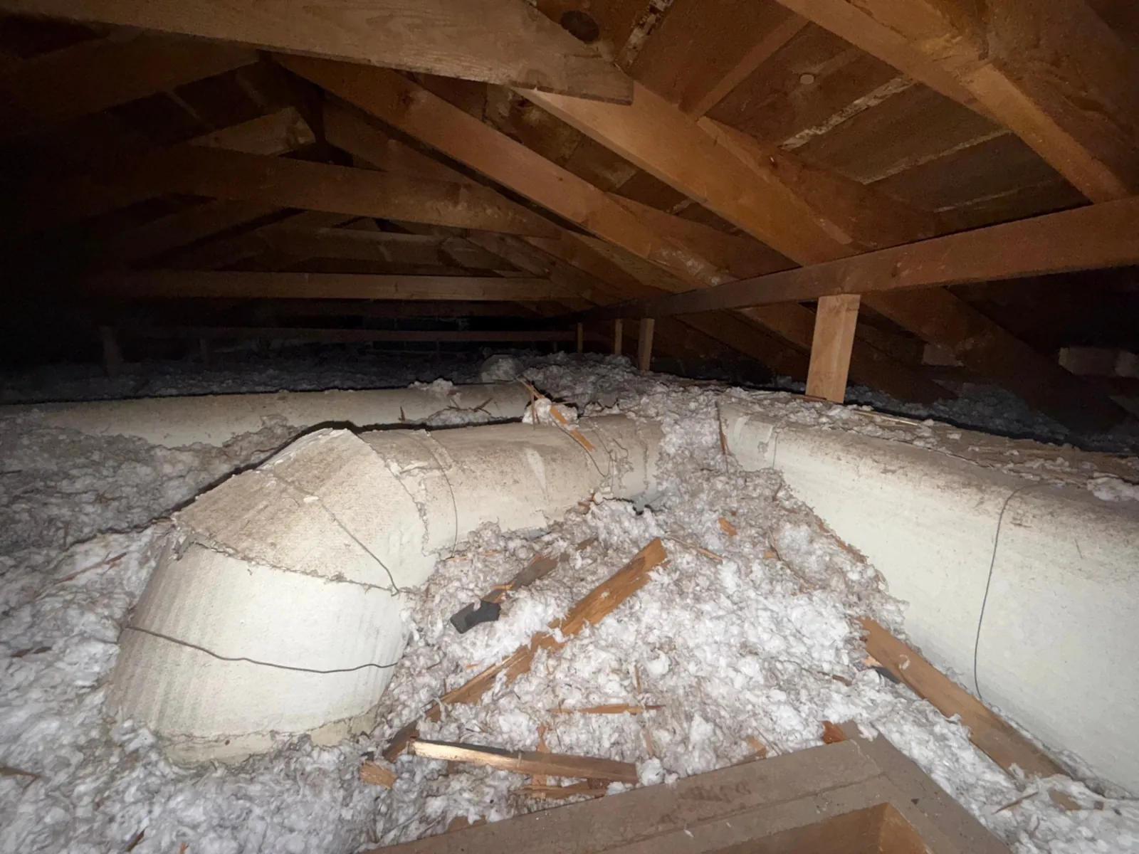 Loose-fill vermiculite insulation in a Colorado attic suspected of containing Zonolite asbestos, inspected before remediation
